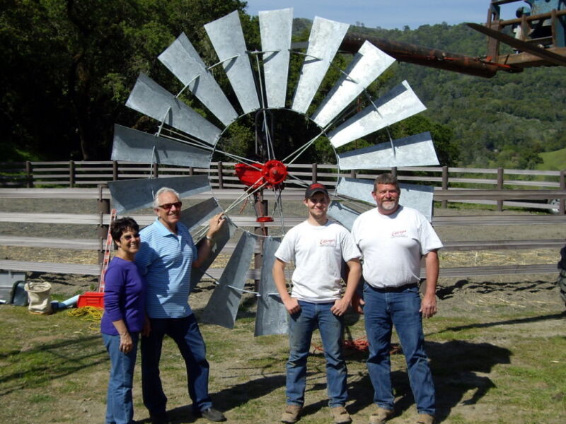 Happy people in front of windmill