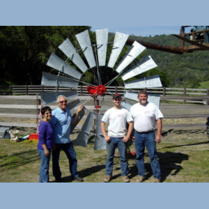 Happy people in front of windmill