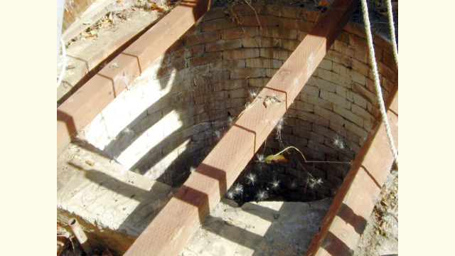 hand dug well under windmill