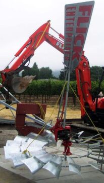 installing windmill with backhoe